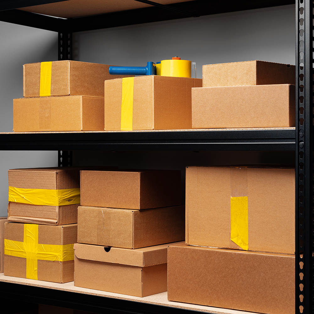 Boxes stacked on a shelving unit for business inventory storage.